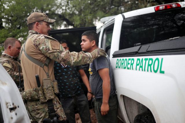 Members of the Border Patrol Search, Trauma, and Rescue Unit near Falfurrias, Texas, apprehend an immigrant from Guatemala June 19. Pope Francis told Reuters he stands with the U.S. bishops in their condemnation of the Trump administration's immigration policy has led to children being held in government shelters while their parents are detained in federal prison. (CNS photo/Adrees Latif, Reuters)